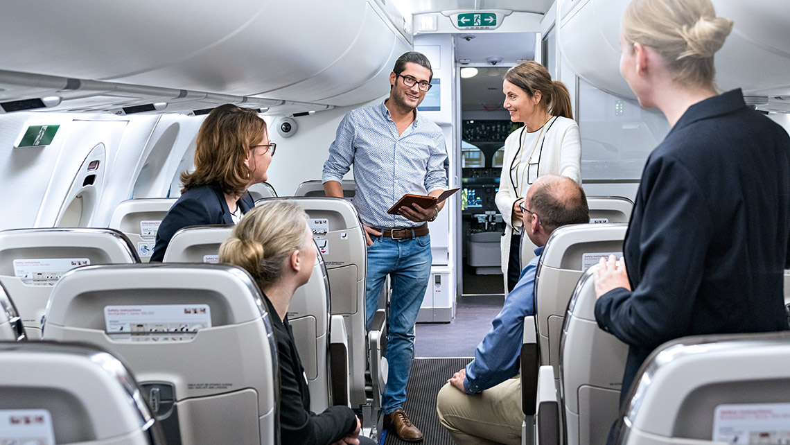 A group with training participants in an aircraft cabin
