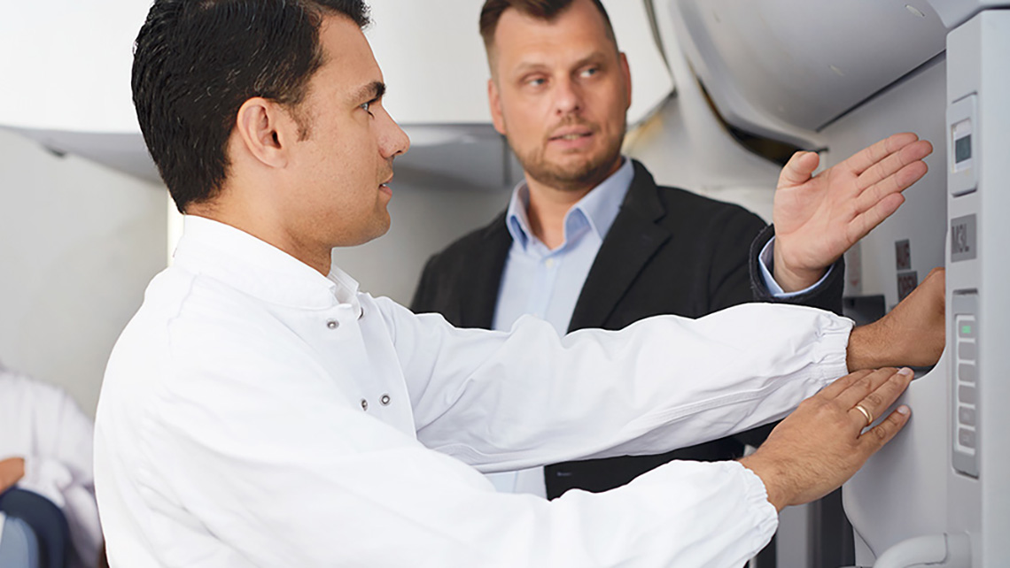 An instructor instructs a trainee in the opening of an aircraft door