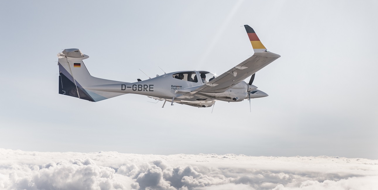 A training aircraft of the European Flight Academy above the clouds.
