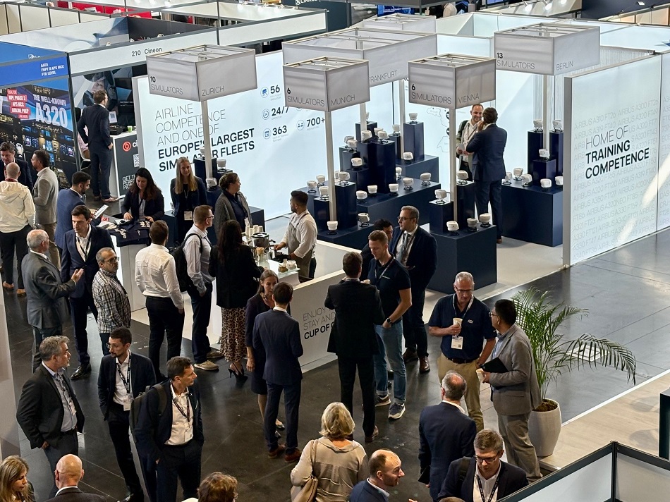 EATS 2024 exhibition booth with trade show visitors.