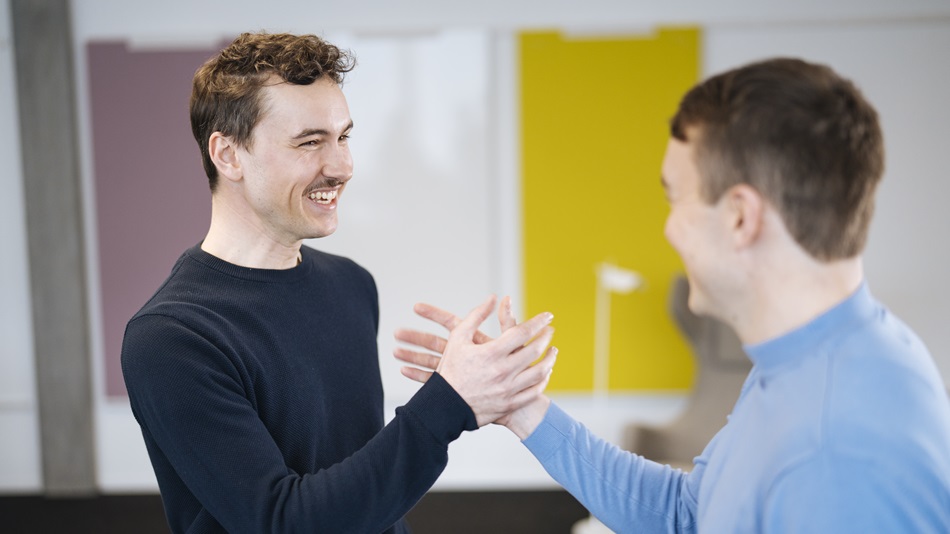 A person is sitting at a desk with a laptop and documents.